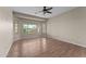 A spacious bedroom with wood flooring, large windows, and neutral-toned walls at 27248 W Mohawk Ln, Buckeye, AZ 85396
