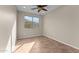 Simple bedroom with a large window and tile flooring offers a cozy, neutral space at 27248 W Mohawk Ln, Buckeye, AZ 85396
