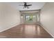 An empty bedroom with wood flooring, large windows, and a ceiling fan at 27248 W Mohawk Ln, Buckeye, AZ 85396