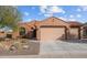 Charming single-story home with a tile roof, a two-car garage and desert landscaping at 27248 W Mohawk Ln, Buckeye, AZ 85396