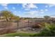 Backyard view of the community golf course, lush landscape, and wrought iron fence at 27248 W Mohawk Ln, Buckeye, AZ 85396