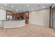Bright kitchen area with tile flooring, wood cabinets, stainless steel appliances, and a large window at 27248 W Mohawk Ln, Buckeye, AZ 85396