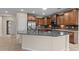 Close-up of the kitchen featuring a kitchen island with a sink and stainless-steel appliances at 27248 W Mohawk Ln, Buckeye, AZ 85396