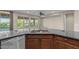 A kitchen with a large gray island, stainless steel dishwasher and sink with a view of the backyard at 27248 W Mohawk Ln, Buckeye, AZ 85396