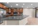 Modern kitchen with stainless steel appliances, wooden cabinets and stone countertops at 27248 W Mohawk Ln, Buckeye, AZ 85396