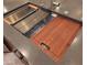 Modern kitchen sink equipped with cutting board and dish drying rack at 27248 W Mohawk Ln, Buckeye, AZ 85396