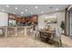 Open-concept kitchen featuring rich wood cabinetry, stone countertops, and adjacent dining area at 27248 W Mohawk Ln, Buckeye, AZ 85396