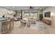 Open concept living space with tile flooring, natural light, and seamless access to the dining area at 27248 W Mohawk Ln, Buckeye, AZ 85396
