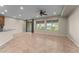 Spacious living area with tile floors, a ceiling fan, and sliding glass doors to the backyard at 27248 W Mohawk Ln, Buckeye, AZ 85396