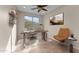 Home office with desk, shelves, and an accent chair, offering a stylish workspace at 27248 W Mohawk Ln, Buckeye, AZ 85396