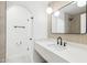 Modern bathroom featuring white countertops, black fixtures, walk-in shower and neutral wood-look tile at 3002 N 32Nd St # 15, Phoenix, AZ 85018