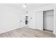 Bright bedroom with wood-look floors, large closet, and view to kitchen at 3002 N 32Nd St # 15, Phoenix, AZ 85018