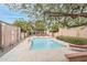 Community pool surrounded by stone pavers and lush landscaping at 3002 N 32Nd St # 15, Phoenix, AZ 85018