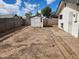 Fenced backyard featuring a storage shed and desert landscaping, ideal for low-maintenance outdoor living at 3123 W Holly St, Phoenix, AZ 85009