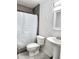 Bathroom features a shower with tile surround, vanity, and tile flooring at 3123 W Holly St, Phoenix, AZ 85009
