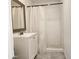 Bathroom features a shower with tile surround, vanity, and tile flooring at 3123 W Holly St, Phoenix, AZ 85009