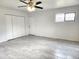Bedroom features a ceiling fan, window, closet, and tile flooring at 3123 W Holly St, Phoenix, AZ 85009