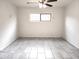 Bedroom features a ceiling fan, window, and tile flooring at 3123 W Holly St, Phoenix, AZ 85009