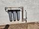 Close-up of a Puragain Water filter system installed on the exterior of the home at 3123 W Holly St, Phoenix, AZ 85009