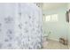 Bright bathroom featuring a floral shower curtain and tiled floors at 3512 N Chambers Ct, Scottsdale, AZ 85251