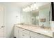 Bright bathroom featuring a dual sink vanity with granite counters, a large mirror, and ample lighting at 3512 N Chambers Ct, Scottsdale, AZ 85251