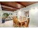 Dining area featuring a wood-paneled ceiling, tile floor, and view of a living space at 3512 N Chambers Ct, Scottsdale, AZ 85251