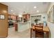 Bright kitchen with stainless steel appliances, tile floors, wood cabinets, and a pass-through window to the dining room at 3512 N Chambers Ct, Scottsdale, AZ 85251