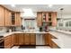 Bright kitchen featuring light wood cabinets, stainless steel appliances and a tile backsplash at 3512 N Chambers Ct, Scottsdale, AZ 85251