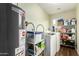 Well-equipped laundry room featuring a washer, dryer, and ample storage shelves for organization at 3512 N Chambers Ct, Scottsdale, AZ 85251