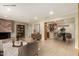 Open-concept living room featuring a brick fireplace and seamless flow to the kitchen at 3512 N Chambers Ct, Scottsdale, AZ 85251