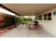 Outdoor patio featuring comfortable seating, a grill, and a beautiful view of the lush backyard at 3512 N Chambers Ct, Scottsdale, AZ 85251