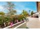 Relaxing outdoor patio with seating area, surrounded by colorful flowers and lush greenery at 3512 N Chambers Ct, Scottsdale, AZ 85251