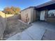 View of the backyard with partial concrete patio and privacy fence at 3646 N 67Th Ave # 83, Phoenix, AZ 85033