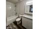 Renovated bathroom features white marble-look shower tile, granite counter, and white cabinets at 3646 N 67Th Ave # 83, Phoenix, AZ 85033