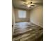 Bedroom with modern ceiling fan, window, and wood-look floors at 3646 N 67Th Ave # 83, Phoenix, AZ 85033