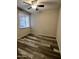 Bedroom with modern ceiling fan, window with blinds, and wood-look floors at 3646 N 67Th Ave # 83, Phoenix, AZ 85033