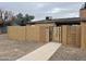 Tan block wall with a gated entry and walkway to this residential home at 3646 N 67Th Ave # 83, Phoenix, AZ 85033