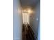 Hallway features wood-look floors and white linen closet at 3646 N 67Th Ave # 83, Phoenix, AZ 85033