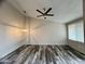 Bright living room with wood-look floors, modern lighting, and a ceiling fan at 3646 N 67Th Ave # 83, Phoenix, AZ 85033