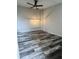 Bright living room with wood-look floors, modern lighting, and a ceiling fan at 3646 N 67Th Ave # 83, Phoenix, AZ 85033