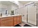 Bathroom showcasing a double sink vanity, glass-enclosed shower, and neutral tile flooring at 36867 N Yellowstone Dr, San Tan Valley, AZ 85140