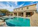 Relax and unwind by the sparkling pool, complete with a rock waterfall and a covered patio at 41011 W Walker Way, Maricopa, AZ 85138