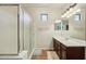 Bathroom featuring a walk-in shower with glass door, vanity with mirror, and tile flooring at 41011 W Walker Way, Maricopa, AZ 85138