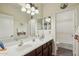 Bright bathroom featuring a double sink vanity, framed mirrors, and a combined shower and tub at 41011 W Walker Way, Maricopa, AZ 85138