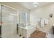 Bathroom with separate shower and tub with glass-block window feature at 41011 W Walker Way, Maricopa, AZ 85138