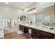 Bathroom with and sinks, granite countertop and a large mirror at 41011 W Walker Way, Maricopa, AZ 85138