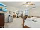 Open bedroom with mini fridge, tv, archway, and decorative design at 41011 W Walker Way, Maricopa, AZ 85138