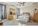 Light and airy bedroom featuring a dresser with mirror, a ceiling fan, and neutral-colored walls at 41011 W Walker Way, Maricopa, AZ 85138