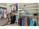Walk-in closet with shelving and hanging rods, providing ample storage space for clothes and accessories at 41011 W Walker Way, Maricopa, AZ 85138