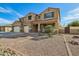 Beautiful two-story home with desert landscaping, featuring a three-car garage and welcoming front porch at 41011 W Walker Way, Maricopa, AZ 85138